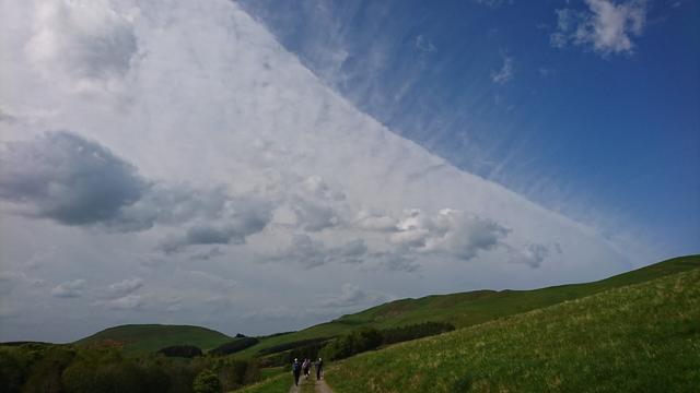 Hilly countryside near Scotland/England border on Pennie Way. Green hills at lower part of image. At the top, an amazingstripe of very high weather front cloud is seen to the north, cutting diagonally across the image.