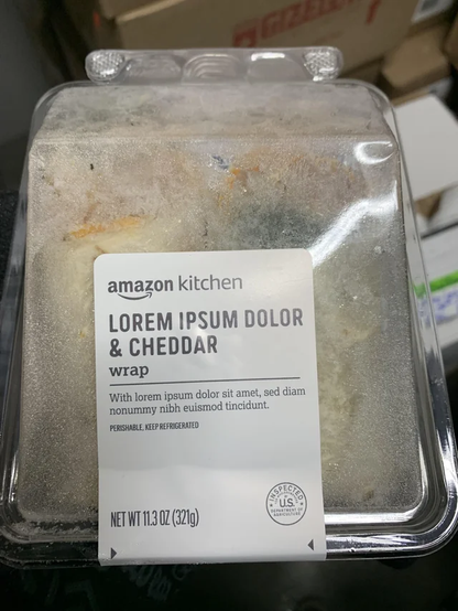 Photo of a wrap from Amazon Kitchen. The sandwich is labelled "Lorem ipsum dolor and cheddar wrap with lorem ipsum dolor sic amet sed diam"