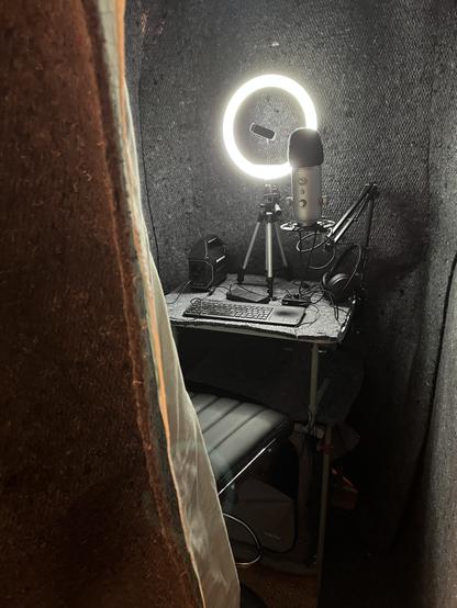 Sound booth with mount for a phone or tablet to use as a second monitor for a computer outside the booth.