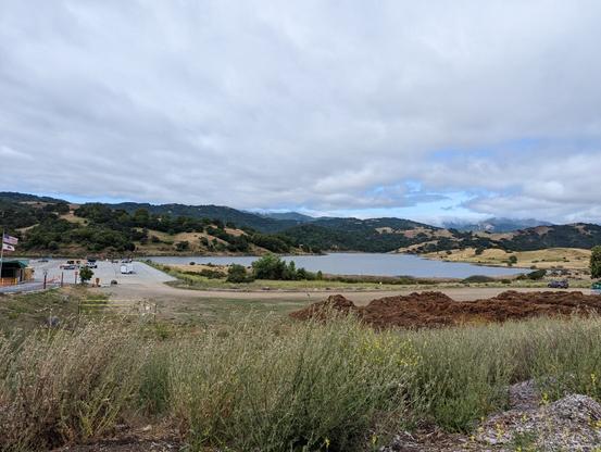 Calero Reservoir is full for the first time in way too many years.  Looking northwest past the parking/boat launch.  It's a Thursday morning and there are already a couple of pickup trucks with boats on trailers backing into the lake.  The county park services have built a brand new Park Ranger and Attendant building at the entrance to collect park fees.  There are plenty of picnic tables with shade structures for those who would like to picnic out here.