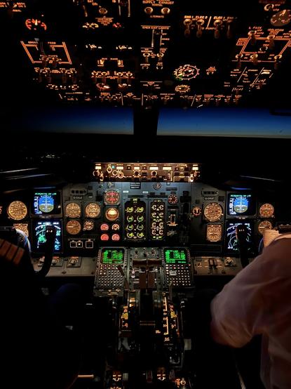 A view of a B737 flight-deck from the jump-seat during a night flight on a lovely clear night.