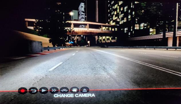 Bumper cam for the same car, racing at night.