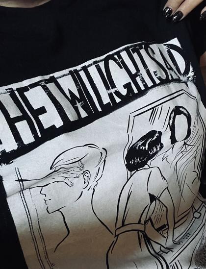 A T-shirt from the band The Twilight Sad, black and white with a woman looking in the mirror. She has no face.