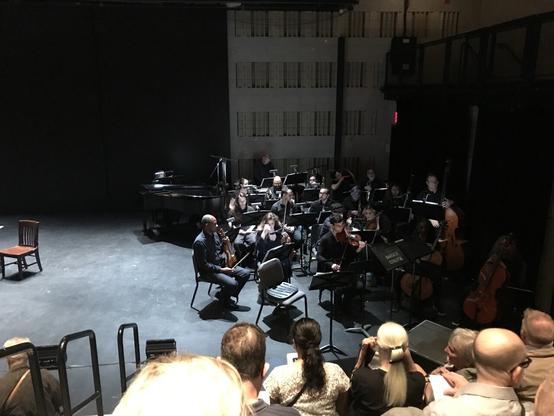 Right side of stage with 19-piece orchestra and piano crammed into a corner