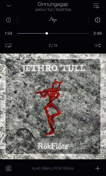 Screenshot of music player showing the album "RökFlöte" by Jethro Tull. Track playing is "Ginnungagap". Cover is a rock effect background in grey with the band name at the top and the title at the bottom. Between them is a stick figure seemingly carved into the stone and painted red, a figure with devil horns standing on one leg and playing a flute. Or a Flöte, apparently.