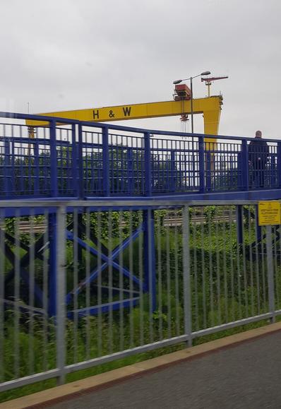 Photo from the train from Belfast to Bangor showing iconic yellow Harland & Wolff crane and platform of #Titanic train stop