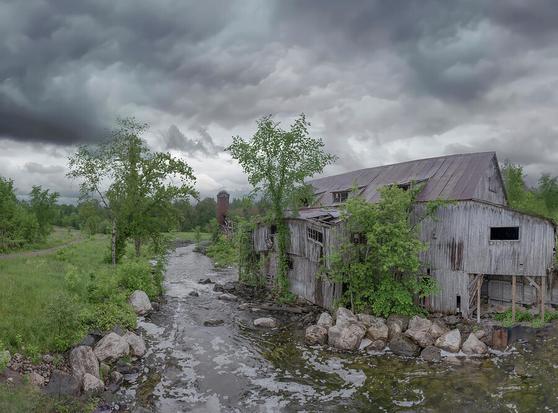 An old mill from pioneer days sits crumbling by a river in the ghost town of Balaclava, Ontario.