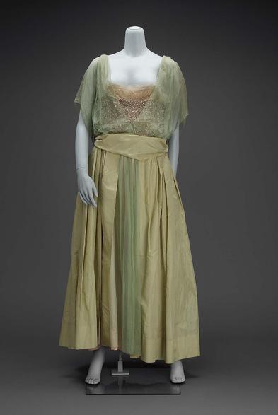 Evening dress; skirt, pale green taffeta, full with deep pouf in center back and open down center front to show green chiffon over pink satin underskirt; bodice, with deep V in center front and back, of green chiffon; wide band of silver glass bead embroidery over pink satin running around lower bodice; short sleeve formed by square of green chiffon with bead tassels on lower corner; green tafetta belt; label on belt: