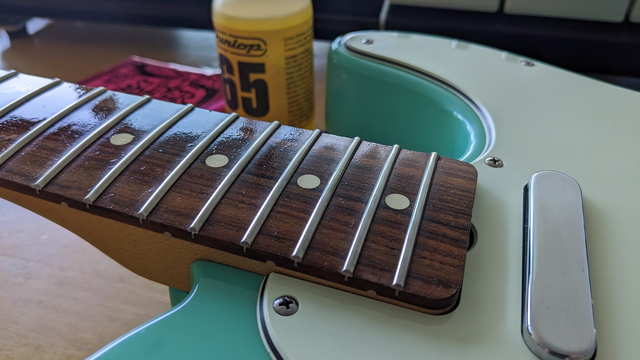 Oily fretboard of a Fender Telecaster guitar.