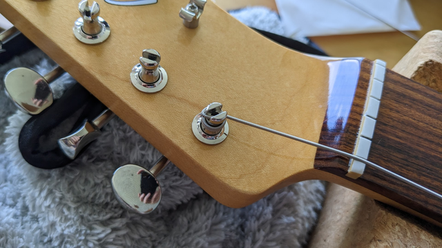 Low e string wound around the nut of a Fender Telecaster guitar.