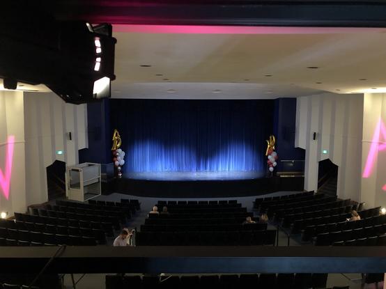 View from the booth of an auditorium with an empty audience. The main drape is closed.