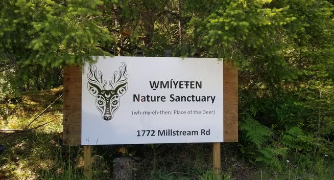 W̱MÍYEŦEN Nature Sanctuary roadside address sign.