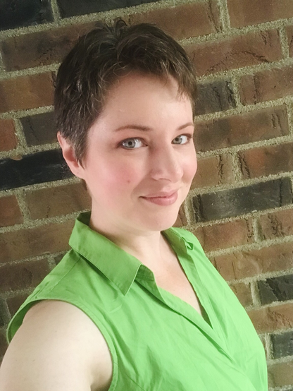Standing in front of a brick wall in a bright green top
