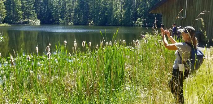 Photo of new friend, Monica, taking nature photos with their phone.