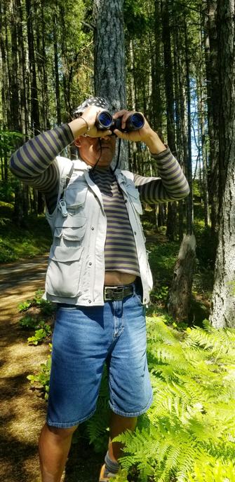 Jim looking for birds with binoculars.