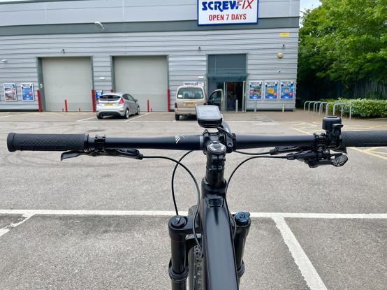 Picture of local ScrewFix with handlebars of mountain bike in the foreground
