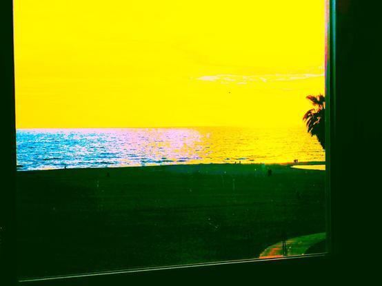 Inspired? Is that the right word by this week's NAmerican climate emergency -- we are still in the midst of - processing. Shot from a window in L.A. in March, altered dusk to mood - Pacific is blue, pink, shades of yellow. Yellow sky with pink clouds, People walking along a boardwalk-path, one man bottom right heading along back to camera. A few others on sand, etc. A darkened palm tree at right sliced by the window -- in front, window glass, frame, ledge.