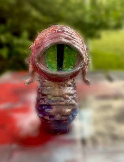 My dianoga, painted to resemble the trash compactor monster from Star Wars: A New Hope.  Tried to focus on the glossy green of the eye, the bloody red coloration around the pupil and on the tentacles and then departing for colors of blues, coppers, and violets.