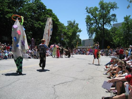 Stilt walkers and giant puppets in an arts parade.