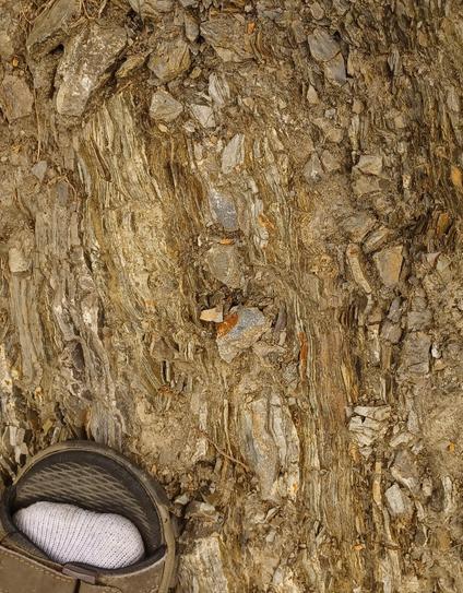 closeup of thick and thin bands of bedrock. some of the bands are made up of dozens of less than mm thick layers of all different colors.