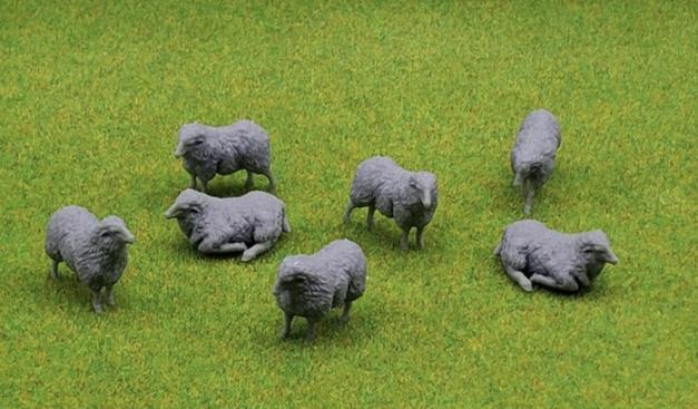 Seven unpainted sheep miniatures in various poses.