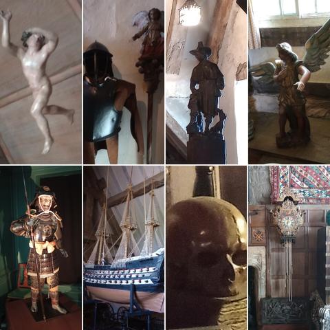 8 items inside Snowshill Manor. A suspended marble figure, a suit of civil war armour, a carved puritan figure, an angel, a samurai, a model galleon, a skull and an ornate clock
