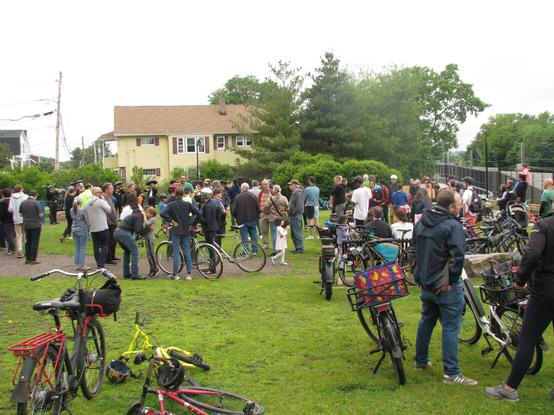 A sizeable crowd of people and bikes gathered in Junction Park, chatting while listening to mariachi music.