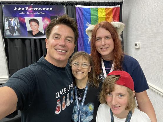 A photo of myself, my wife, my kiddo and Actor John Barrowman.