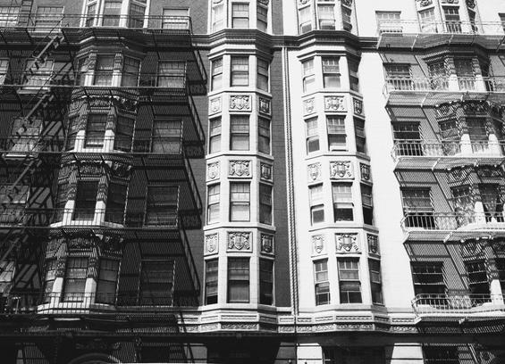a scan of a black and white photo showing the facades of some old black and white buildings in the lower Pacific Heights area of San Francisco