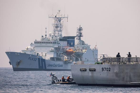 Members of the Philippine Coast Guard participate in a simulation exercise to improve search and rescue collaboration, and enforcement during the first trilateral coast guard exercise between the Philippines, Japan, and the US, at the coast of Bataan on June 6, 2023.