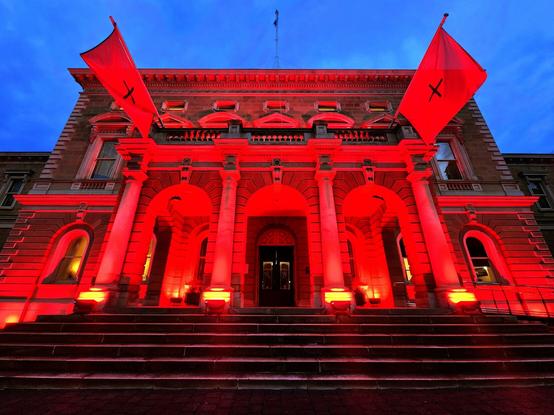 Red lit up old building on Hobart's streets