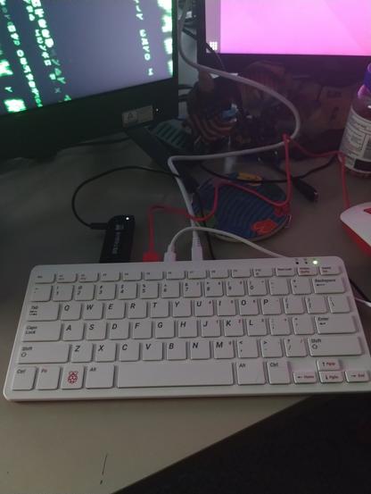 Raspberry PI 400 on very messy desk, with cheap SDR, running Ubuntu Desktop 21.10 and OP25