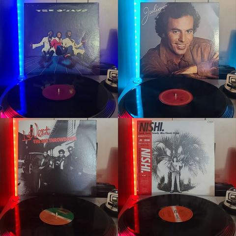 4 images of different vinyl records. Each image has a vinyl on the turntable and the album sleeve displayed. 

Starting at top left going to bottom right, here are the albums displayed: 

The Ojays "The Year 2000"

Julio Iglesias "Julio"

Levert "The Big Throwdown"

Lord, Lord, Lawdy Miss CLawdy Group "Nishi."
