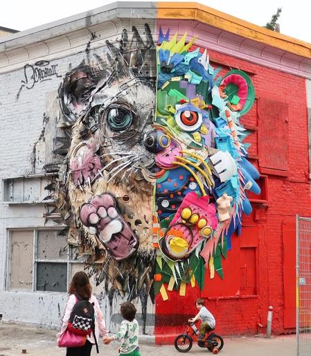 Installation. An art installation on the partly red, partly white exterior walls of a multi-storey corner building. The image of a happy looking hedgehog has been assembled from garbage and sprayed around. Cardboard parts, wires, plastic containers and many more, are like the color of the corner house, separated into a colorful right part of the hedgehog and a white-brown part. Nevertheless, he looks cheerful and looks at us. In the photo, some children are enjoying the colorful hedgehog.