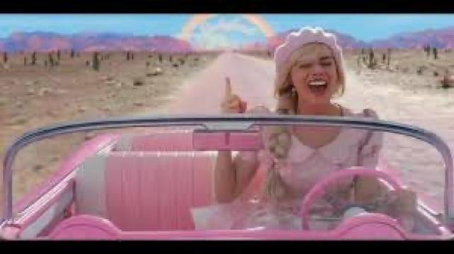 Barbie driving in a pink desert.