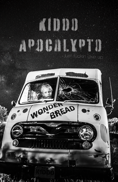 An apocalypse kid sits in a broken down wonder bread truck with a broken windshield.