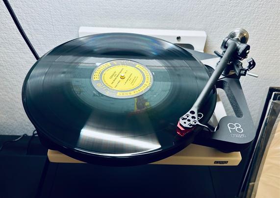 Photo of a record spinning on the skeletal frame of a Rega P8 turntable. 

The centre label is yellow and reads, ‘Prestige,’ in black typeface. 

The tonearm is extended and tracing the opening track.