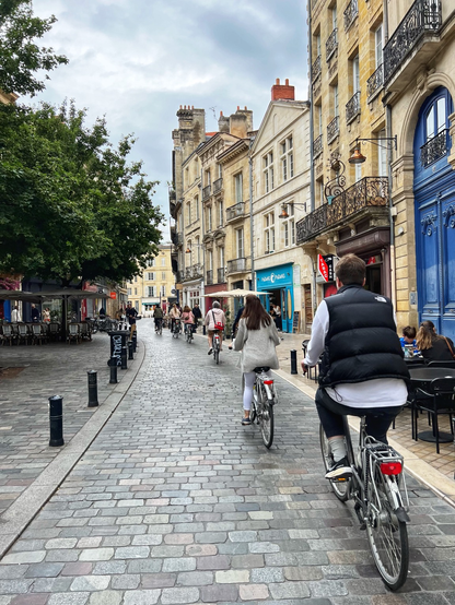 Photo taken by me in 2023 showing a row of people on bikes but no cars.