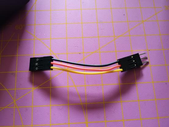 A short cable with three wires, colored black, red, and yellow. It'll be used as extension to connect a servo to my Arduino.