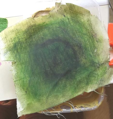 A small piece of fabric, covered in green  intense and aloe vera gel. The colour isn't even, but it is nice and dark, which is what I want.
