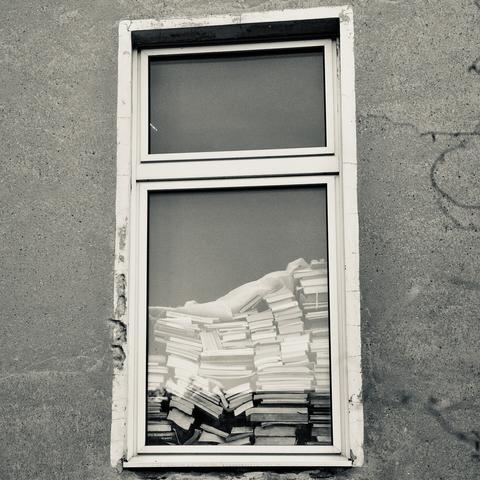 a stack of books seen trough a window