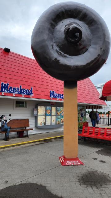 A giant dilly bar statue in front of a Dairy Queen restaurant.