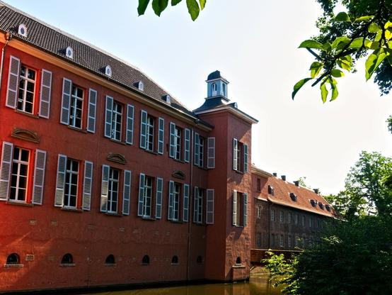 The façade of the castle. Two rows of windows one above the other and another tower.