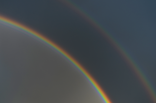 Double rainbow in the dark rainy sky