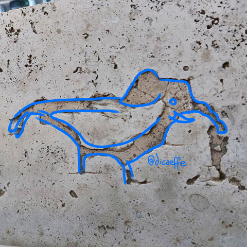 The draw of a bird with the head of an elephantover the photo of a Sidewalk