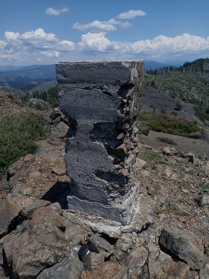 Pillar of rock and cement. The side was made smooth and written on, but it is hard to read now. Some of it says "triangulation" and another bit has "Humboldt" and on another side is "occupied" but the date is hard to read.