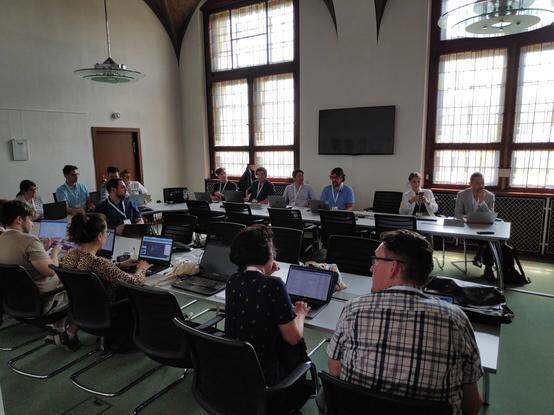 People sitting around tables in a meeting room