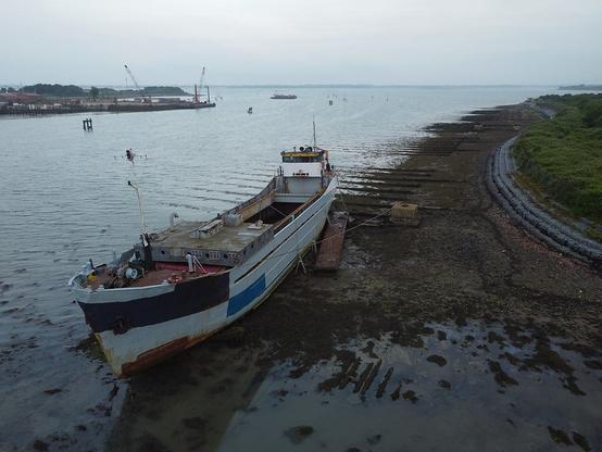 Ship undergoing refurbishment beached on a history D-Day craft maintenance site, Tipner Lake in Portsmouth Harbour.