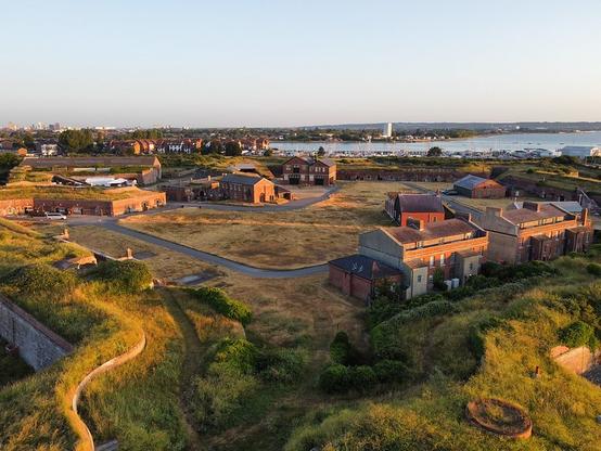 Historic barracks buildings at Fort Cumberland at dawn.