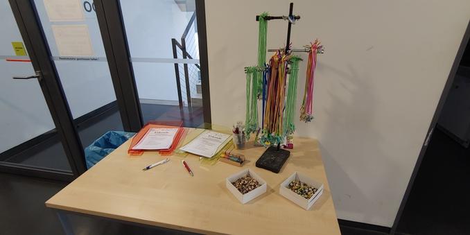 Final where participants get their certificate of attendance and prize: colourful reaction tube on a string